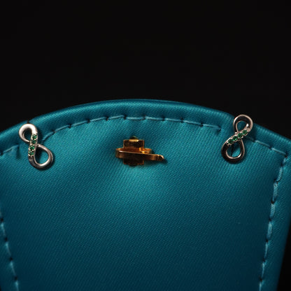 Infinity shape with green stone stud