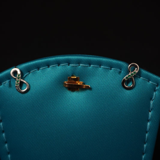 Infinity shape with green stone stud
